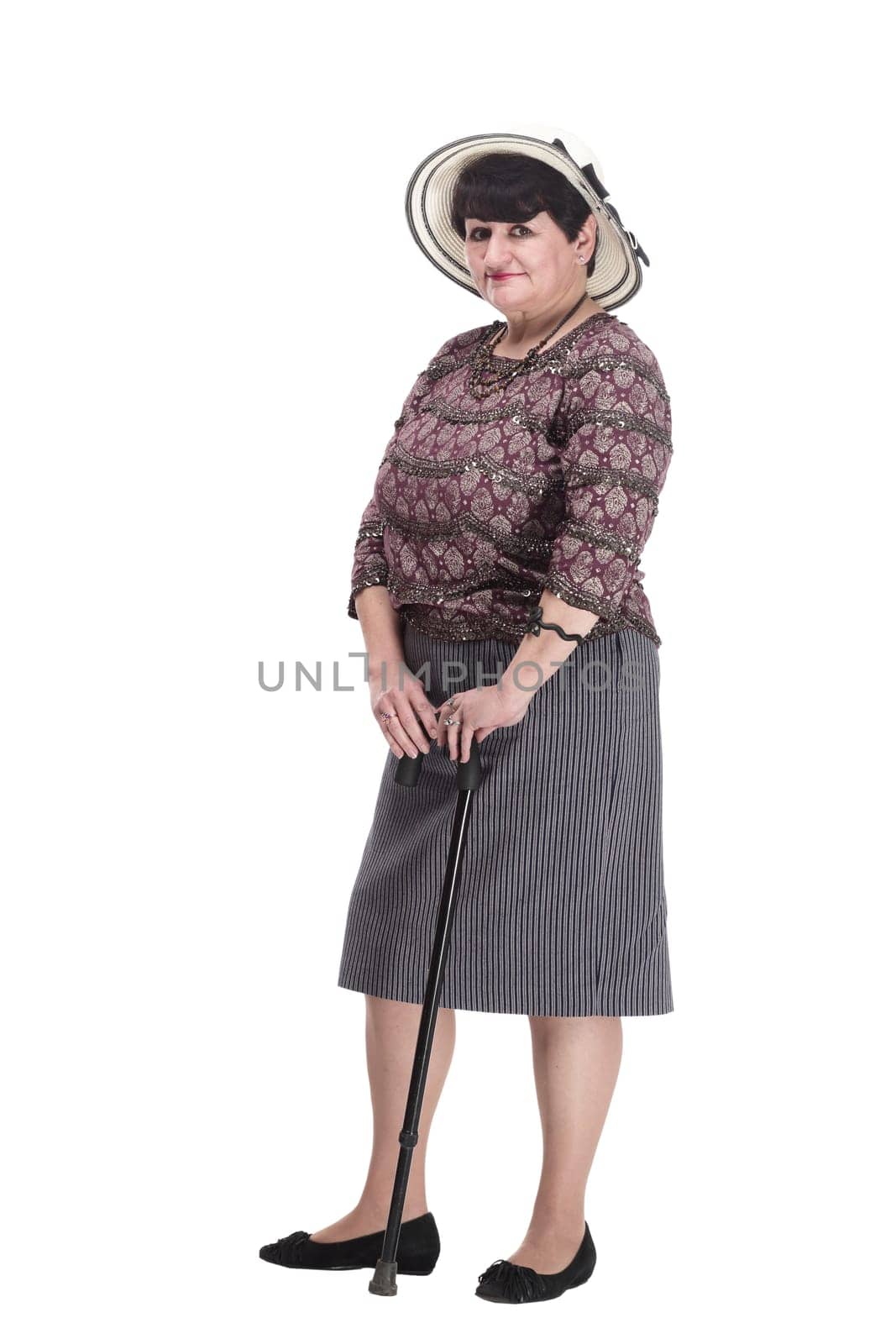 elderly woman with a walking stick in a summer hat. isolated on a white background.