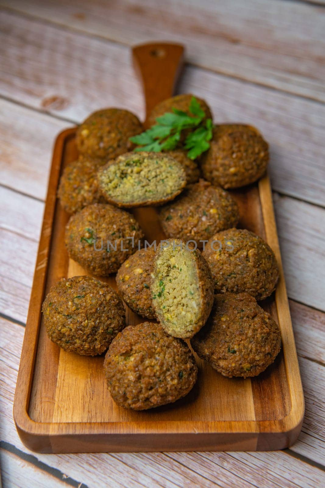 Falafel balls on a wooden cutting board and tahini sauce, High quality photo
