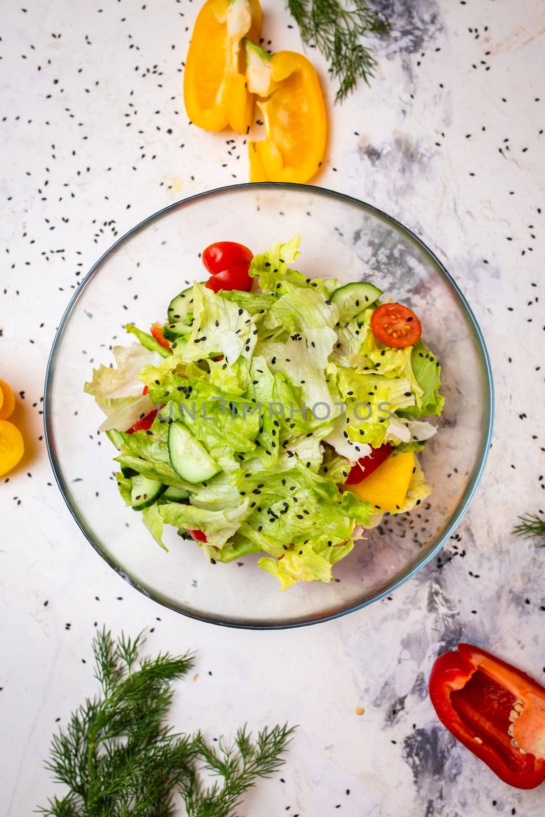 Vegetarian salad with fresh vegetables, lettuce and sesame with tomatoes top view by Pukhovskiy