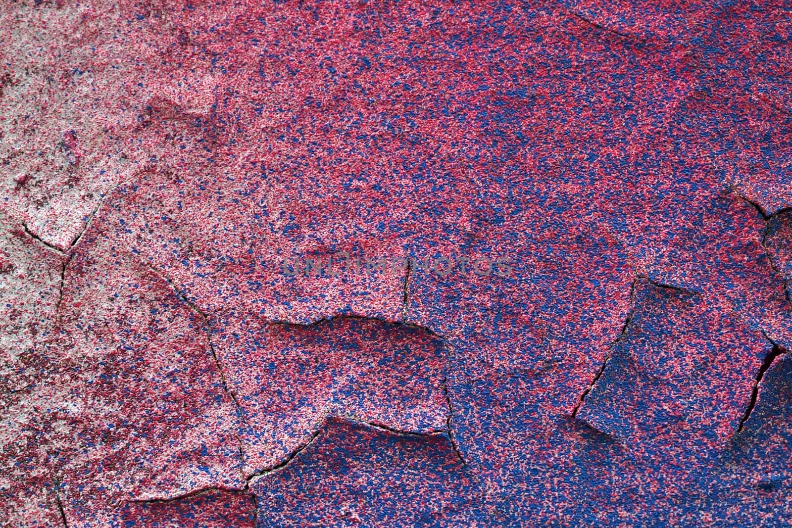 Cracked paint. Pink background with blue spots.