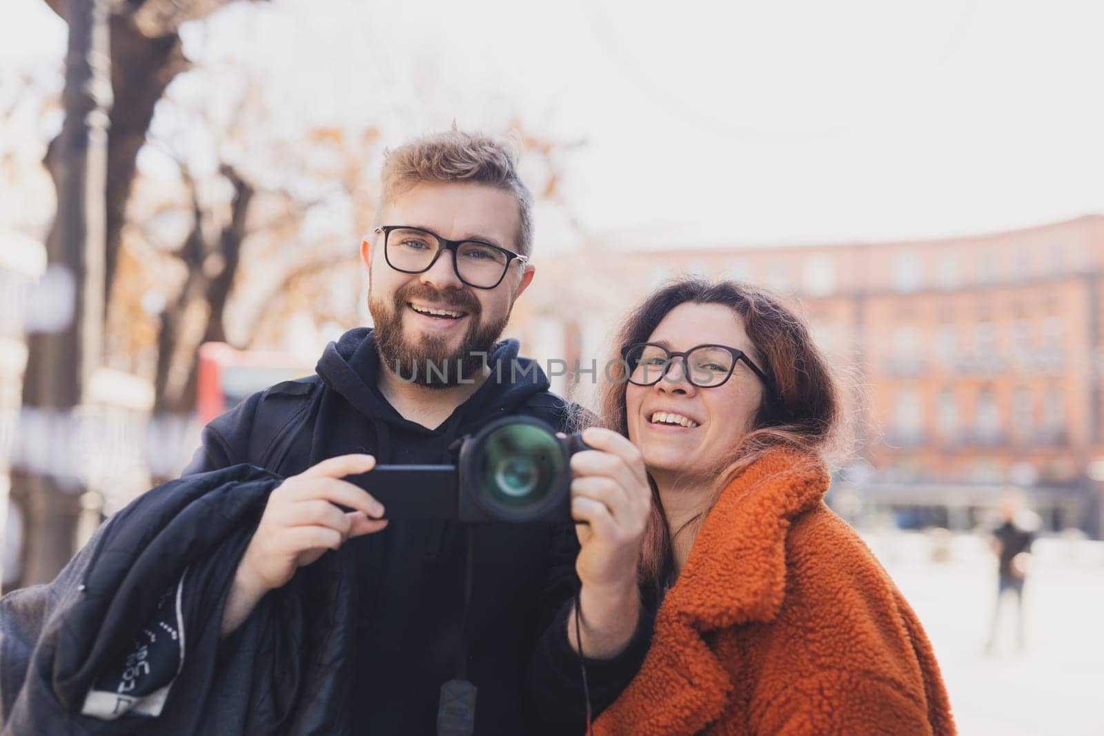 Closeup shot of young couple take selfie outdoor. Young man taking a photo with his girlfriend. Happpy smiling couple taking a selfie in a summer day.