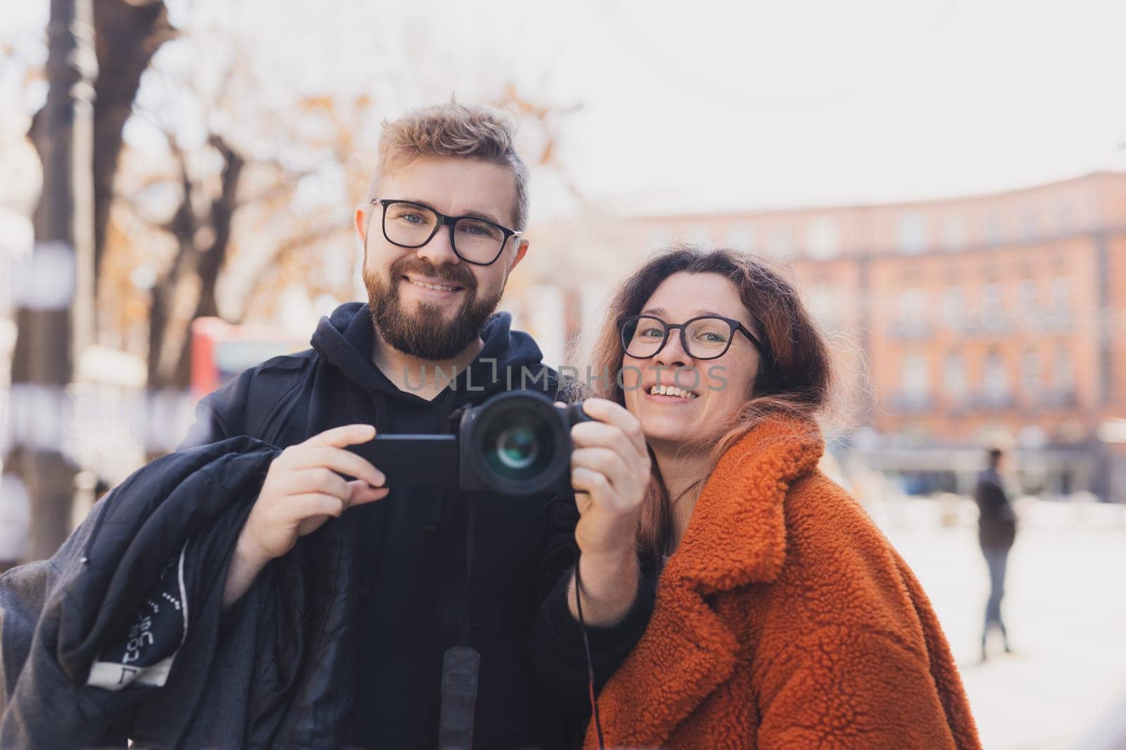 Closeup shot of young couple take selfie outdoor. Young man taking a photo with his girlfriend. Happpy smiling couple taking a selfie in a summer day.