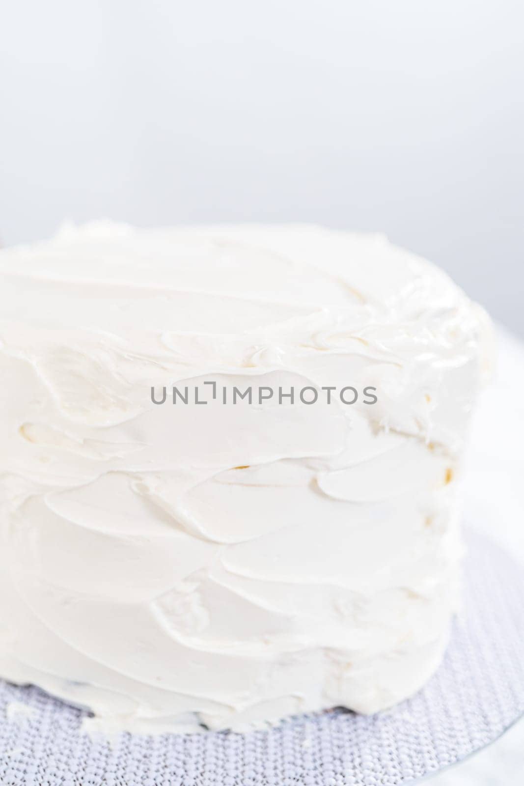 Frosting chocolate cake with vanilla buttercream frosting.