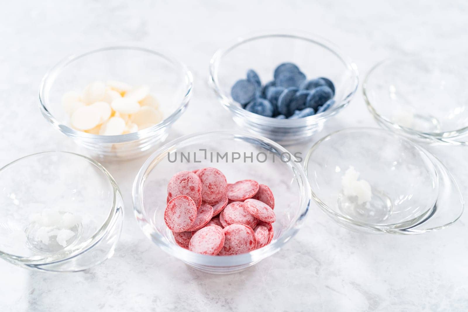 Preparing homemade chocolates. Color chocolate melts in glass pinch bowls.