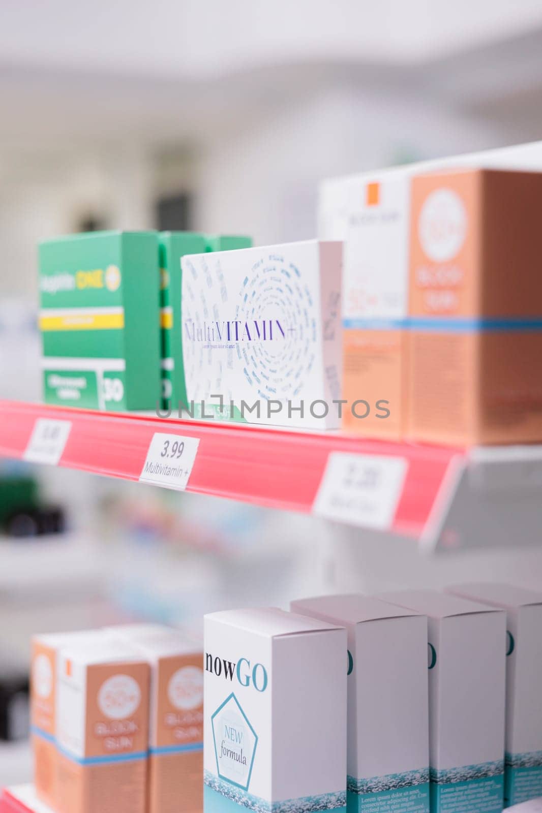 Selective focus of pharmacy shelves full with spf products and pharmaceuticals drugs boxes by DCStudio