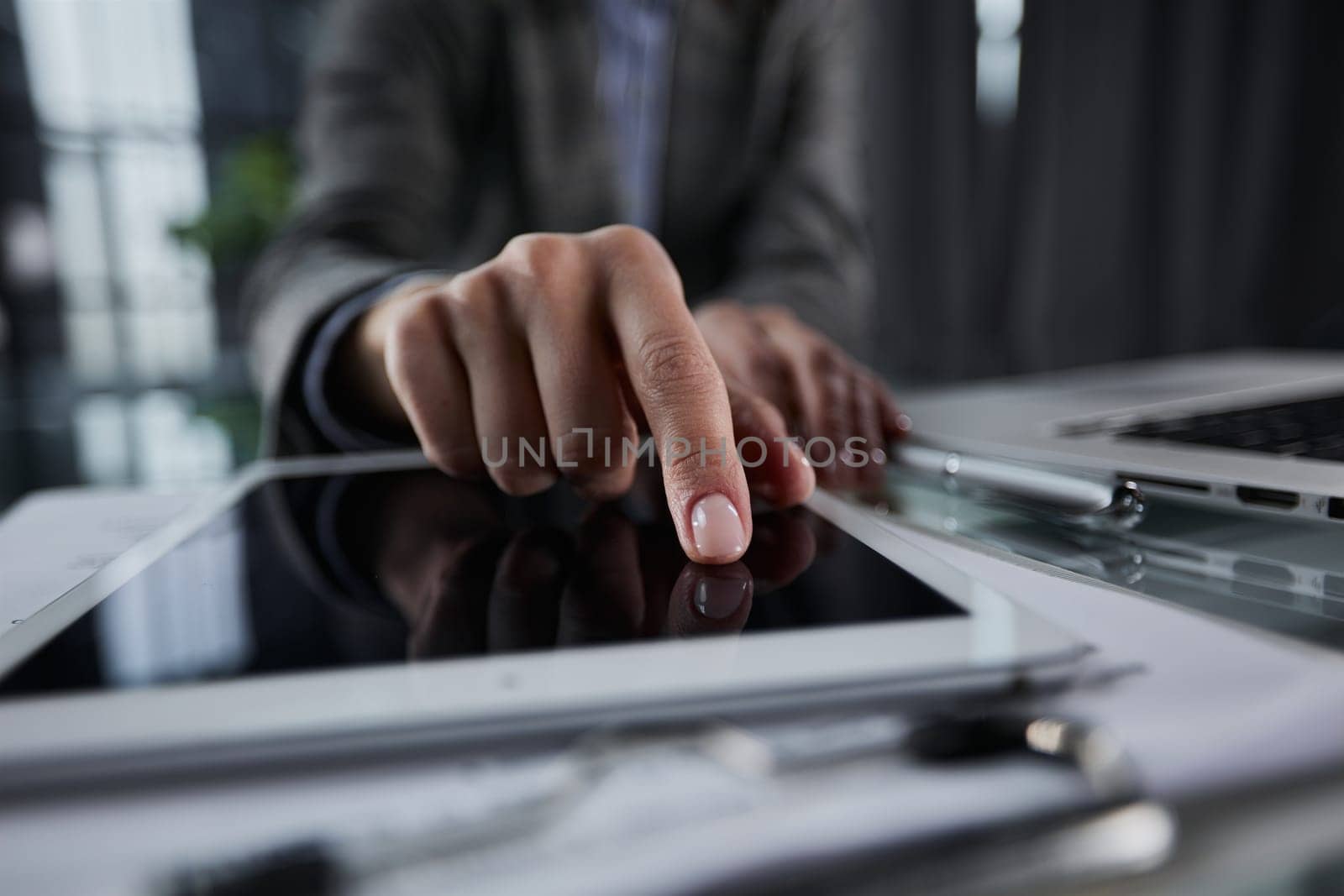 businessman pressing his finger on the screen of the digital tab