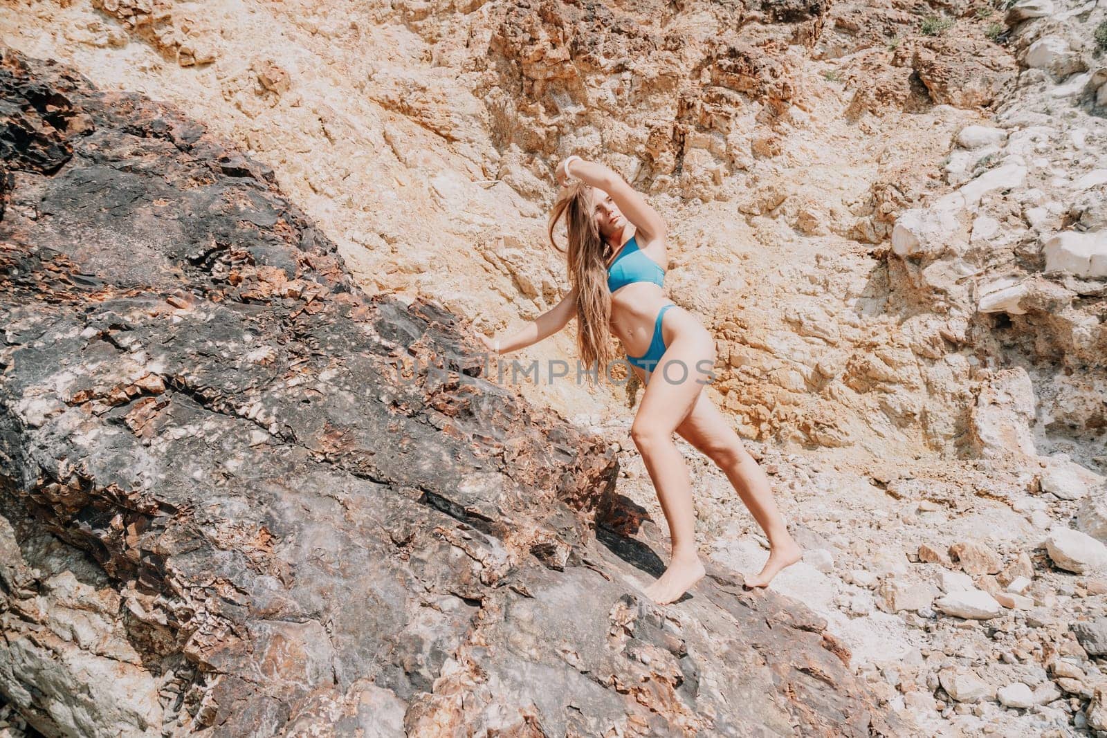 Woman summer travel sea. Happy tourist enjoy taking picture outdoors for memories. Woman traveler posing on the beach at sea surrounded by volcanic mountains, sharing travel adventure journey by panophotograph