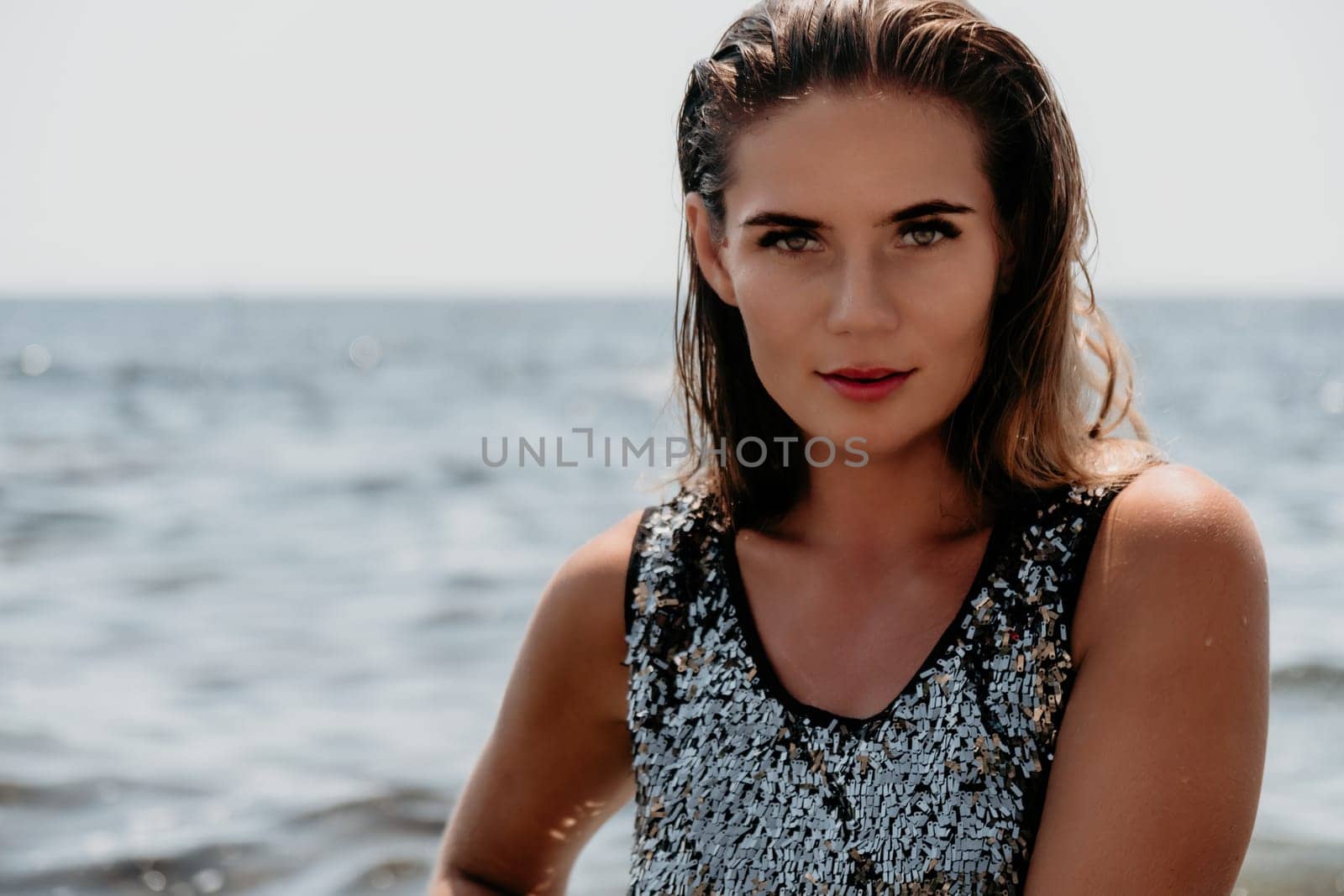 Woman summer travel sea. Happy tourist enjoy taking picture outdoors for memories. Woman traveler posing on the beach at sea surrounded by volcanic mountains, sharing travel adventure journey by panophotograph