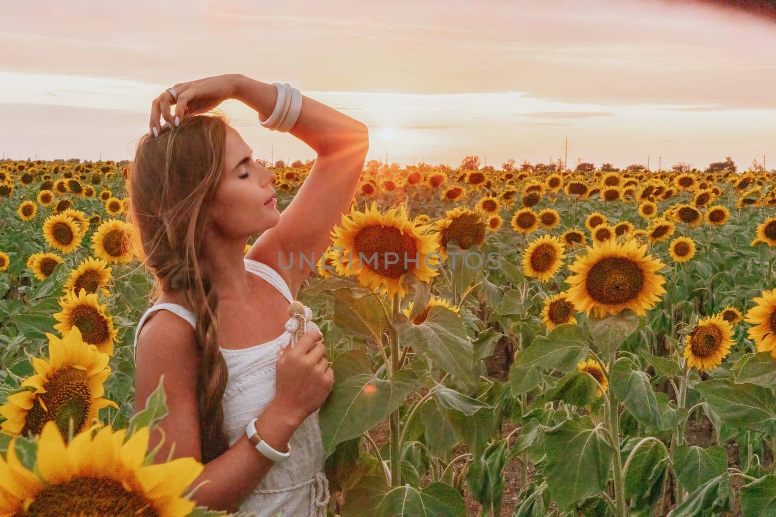 Woman in Sunflower Field: Happy girl in a straw hat posing in a vast field of sunflowers at sunset, enjoy taking picture outdoors for memories. Summer time. by panophotograph