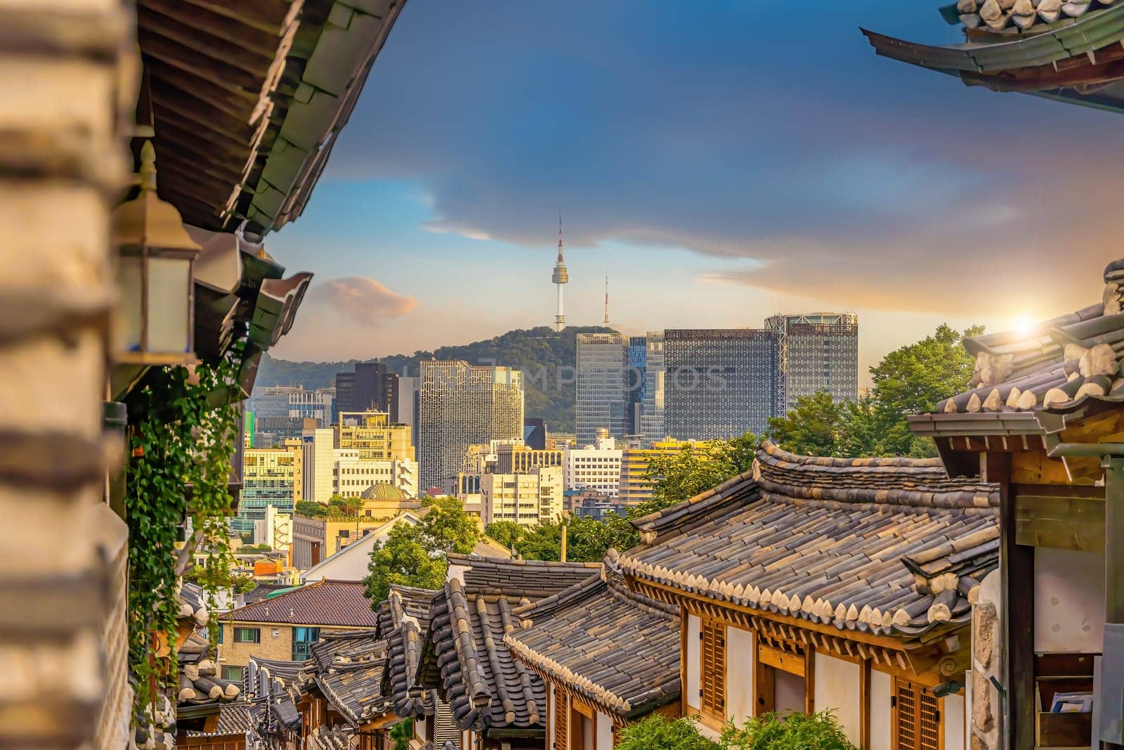 Bukchon Hanok Village with Seoul city skyline, cityscape of South Korea at sunset