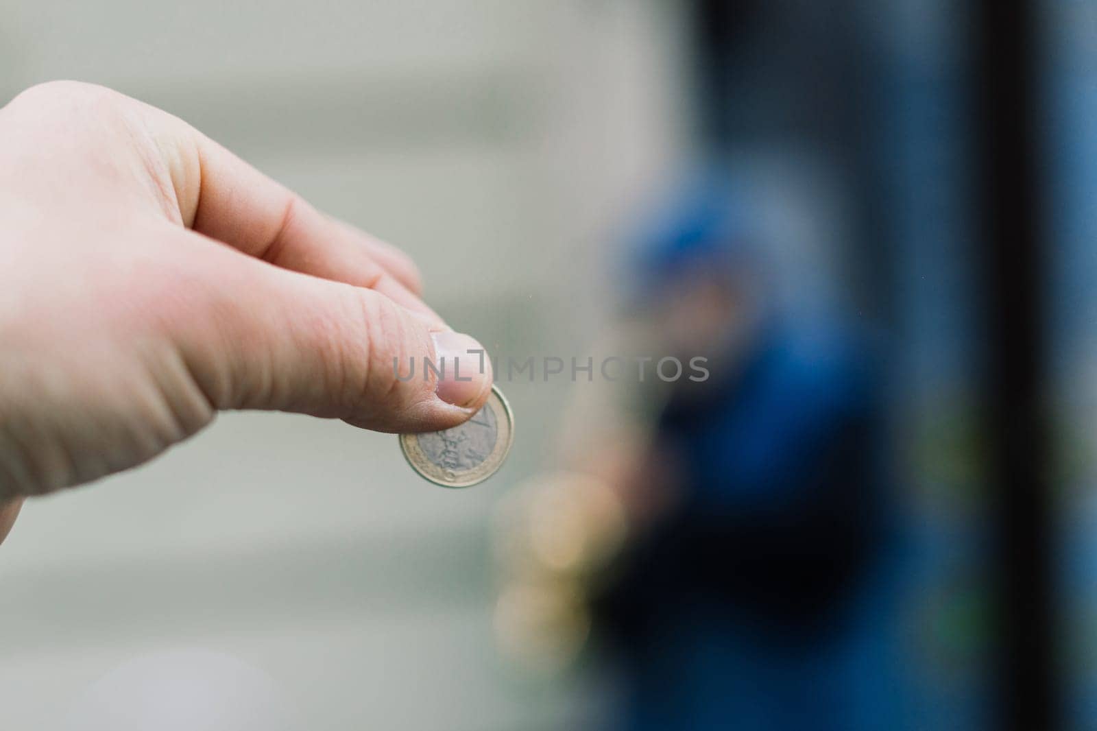 Street old performer musician plays saxofon blurred, coin in a hand focused