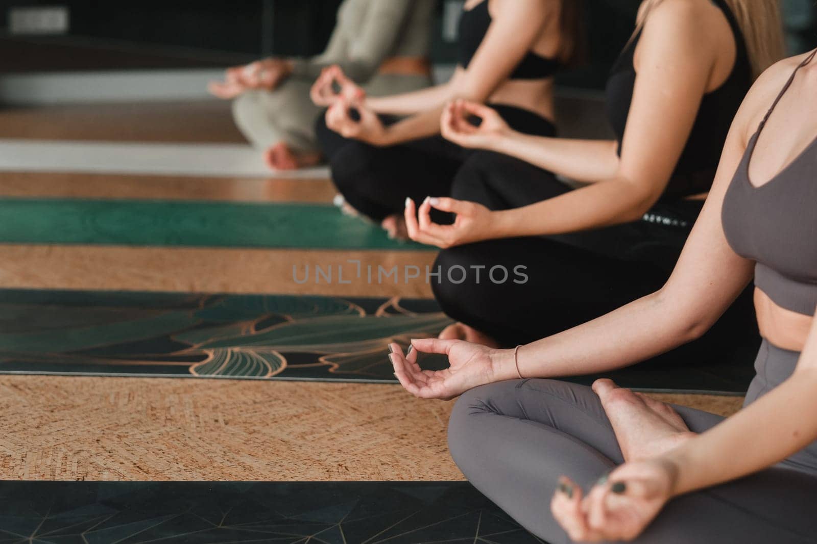 A group of beautiful girls are doing yoga in the fitness room. The concept of a healthy lifestyle.