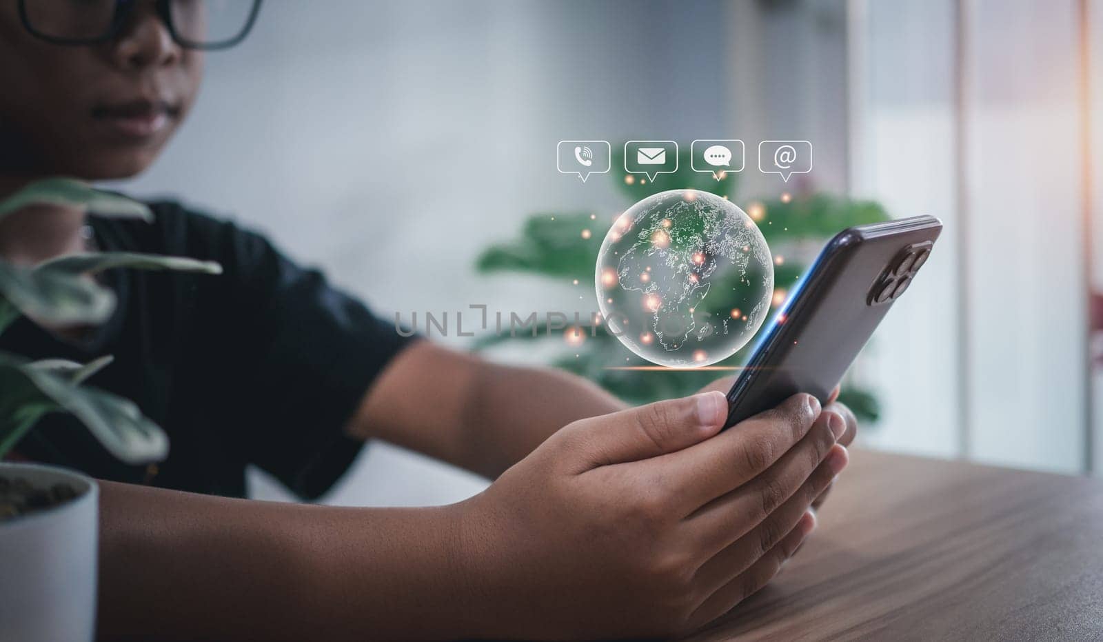 human holding a phone with communication icons Represents a global communications network. by Unimages2527