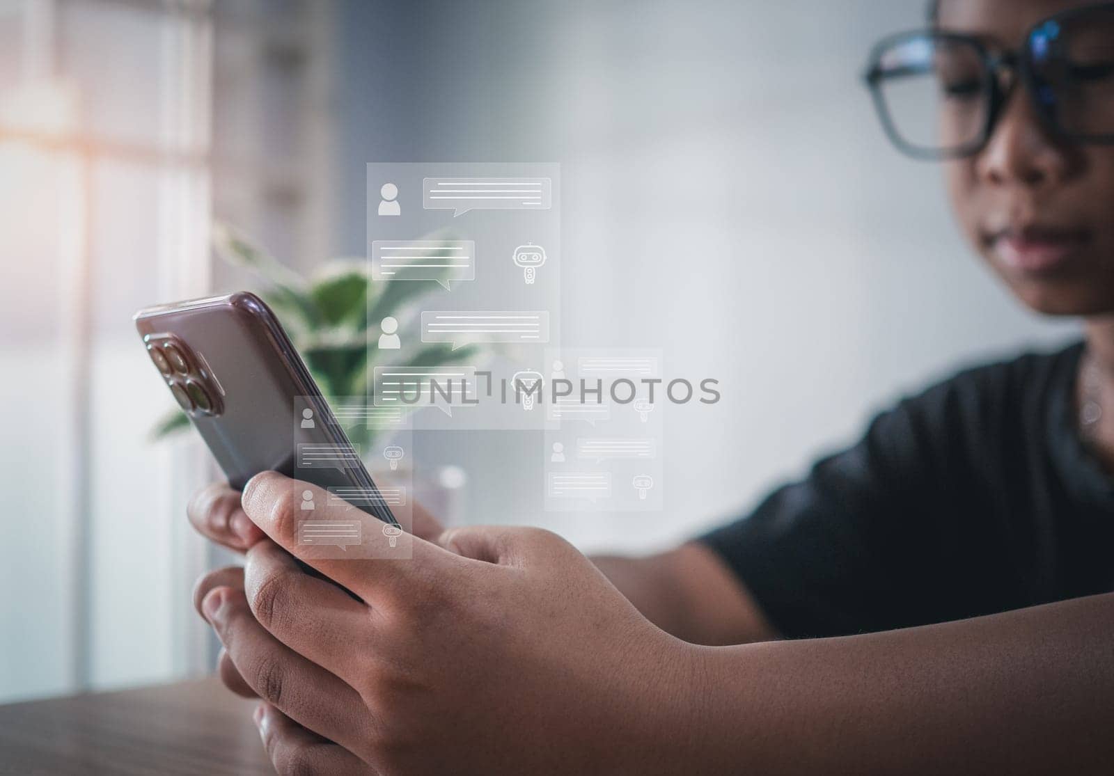 A boy's hand uses a smartphone to type live chat, ask, answer with an artificial intelligence system. chat bot. Ai.