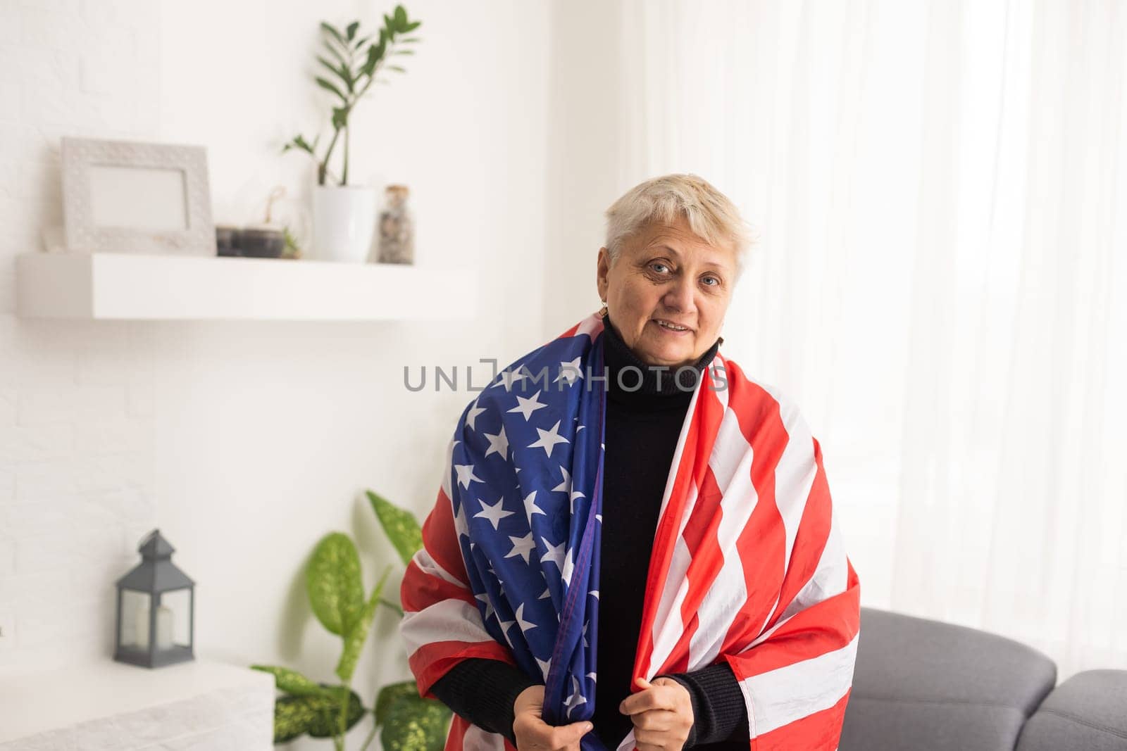 Charming mature woman in USA flag celebrating 4th of july. United States independency day. by Andelov13