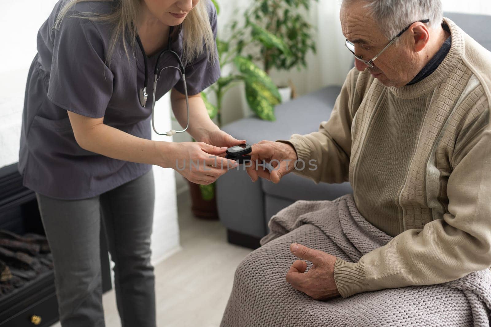 Measurement of oxygen level and pulse rate with a portable pulse oximeter - a man monitors his health.