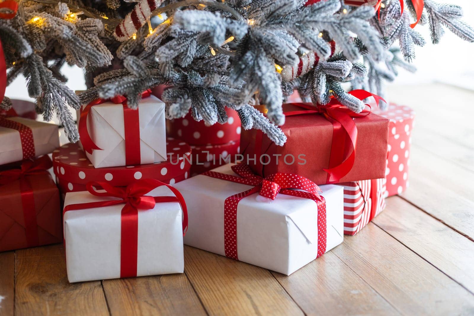 christmas and new year background - gift boxes near decorated christmas tree and copy space.