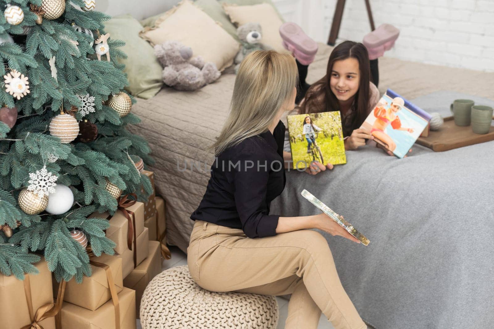 Mother and child hold photo canvas in the interior Christmas.