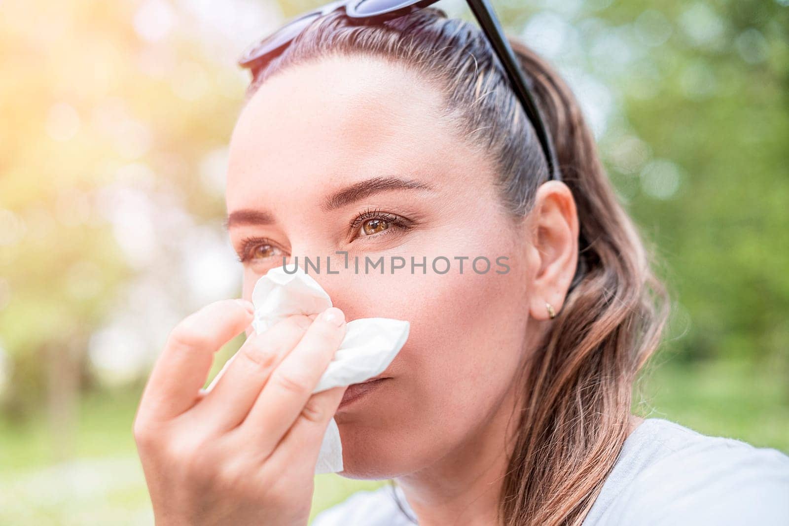 Young woman suffering from allergy outdoors. Pollen allergy symptoms.