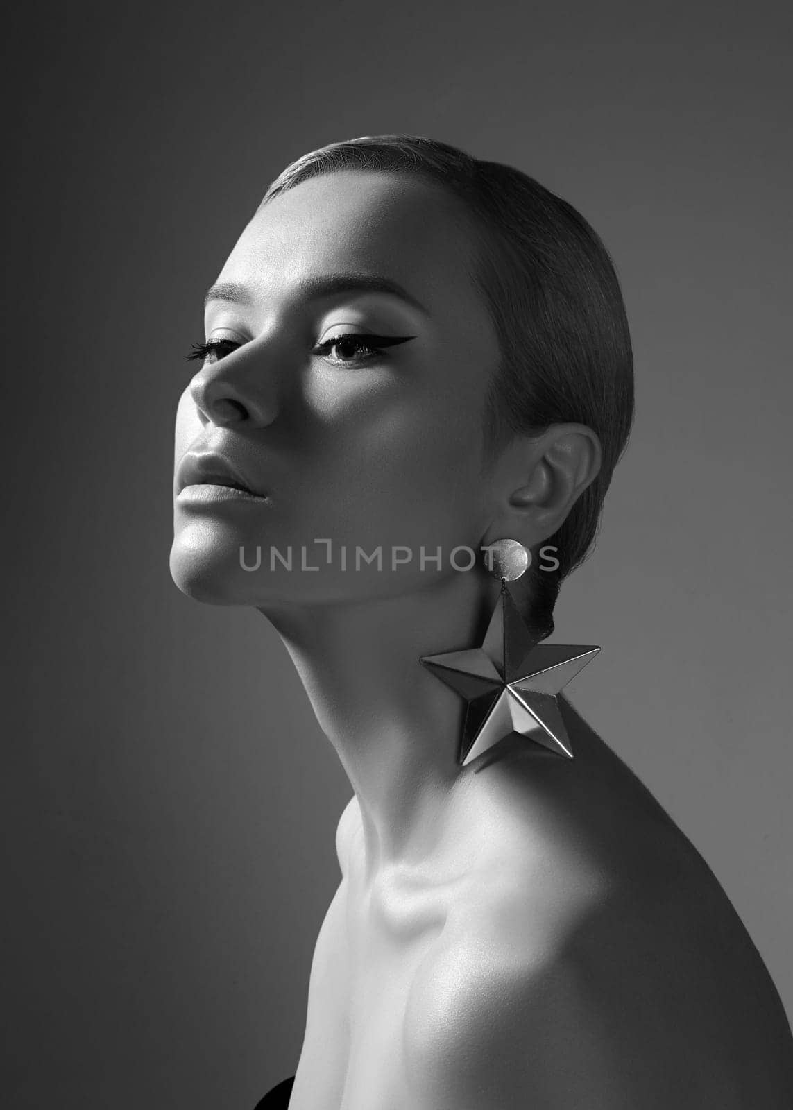 Black and White Art Studio Portrait with Perfect Rembrandt Lighting. Beautiful Elegant Woman in Retro Style with Slicked Back Hair. Elegant Cinema Look