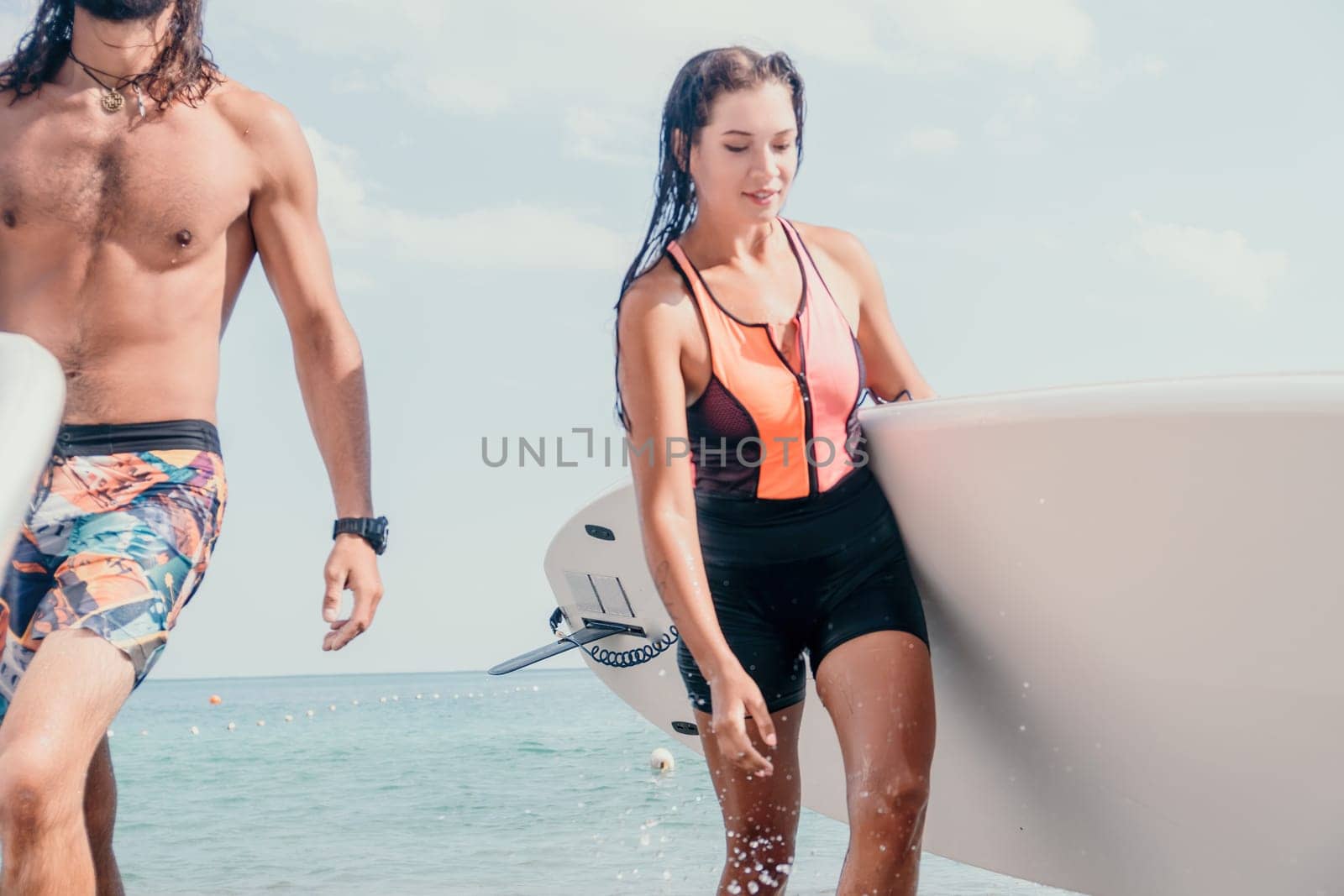 Woman man sea sup. Close up portrait of beautiful young caucasian woman with black hair and freckles looking at camera and smiling. Cute woman portrait in a pink bikini posing on sup board in the sea