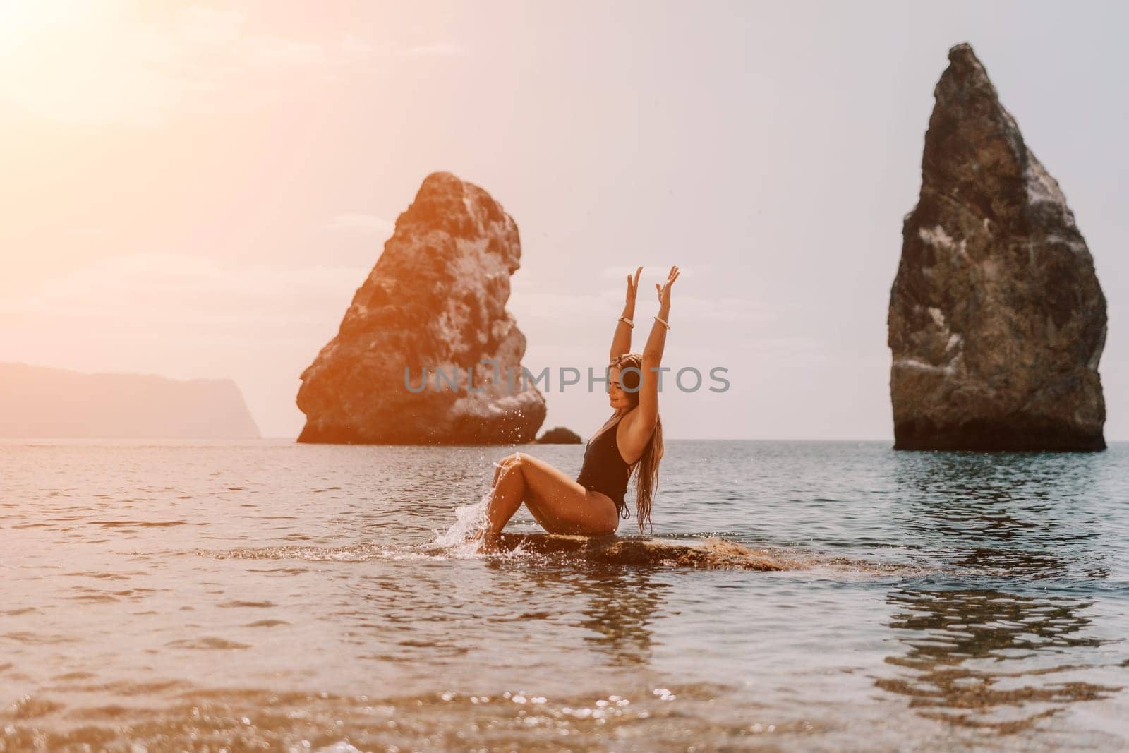 Woman summer travel sea. Happy tourist enjoy taking picture outdoors for memories. Woman traveler posing on the beach at sea surrounded by volcanic mountains, sharing travel adventure journey by panophotograph