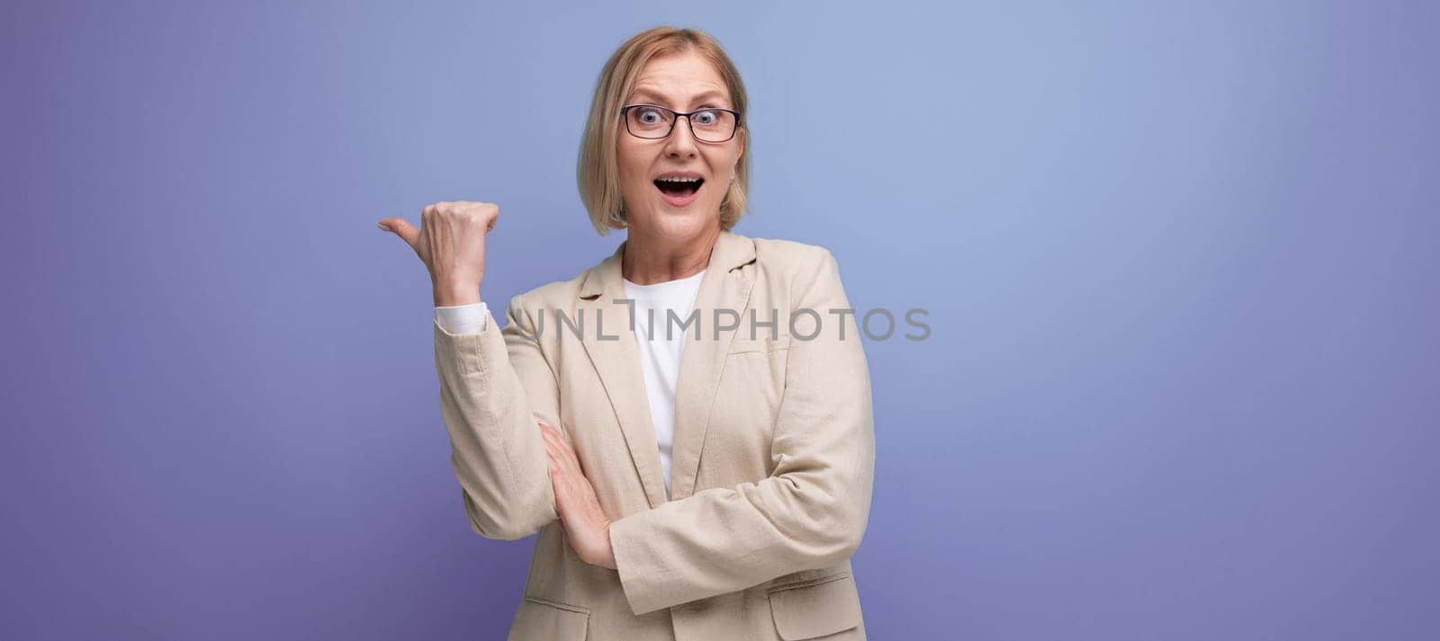 middle-aged business woman smiling in a jacket on a bright studio background with copy space.