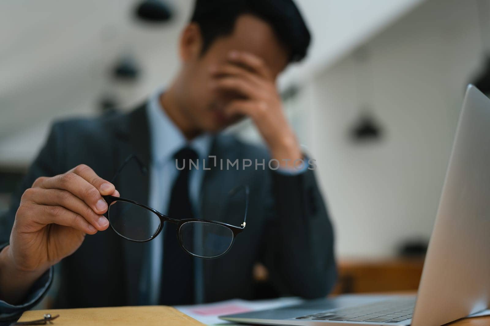 Portrait of business owner, man using computer and financial statements Anxious expression on expanding the market to increase the ability to invest in business