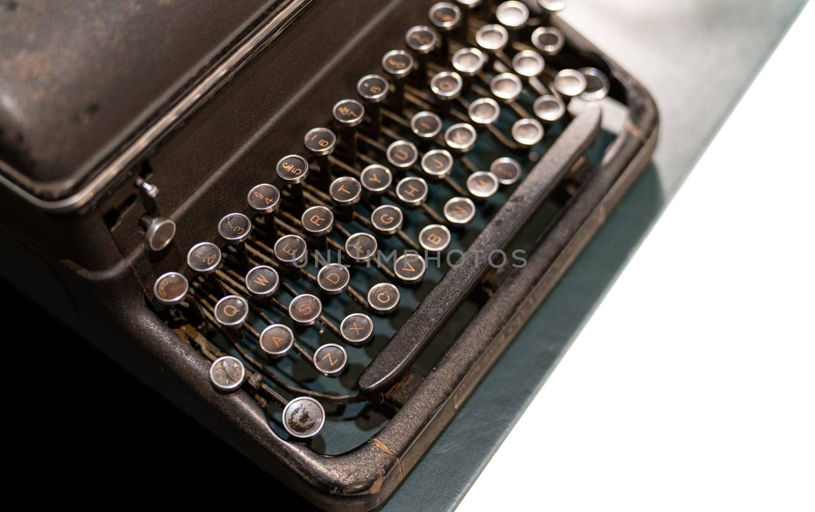 Antique iron typewriter with the classic alphabet keys, a piece of old technology from another era.