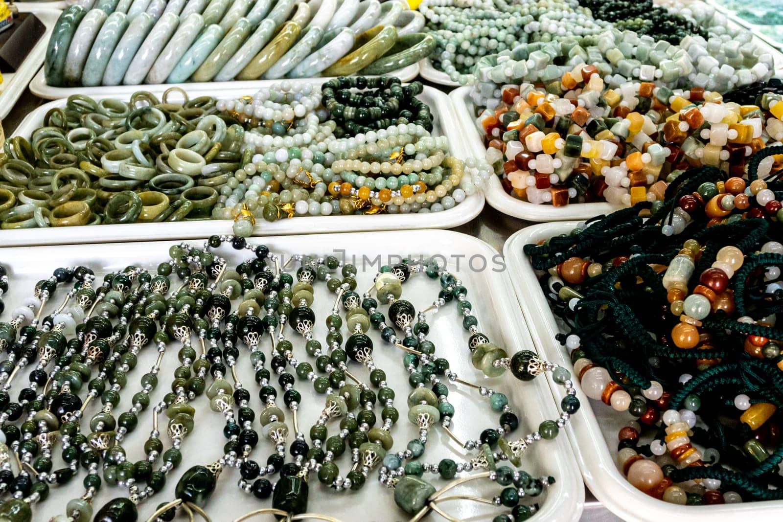 Many jewelry made of stone in a souvenir shop by Satakorn