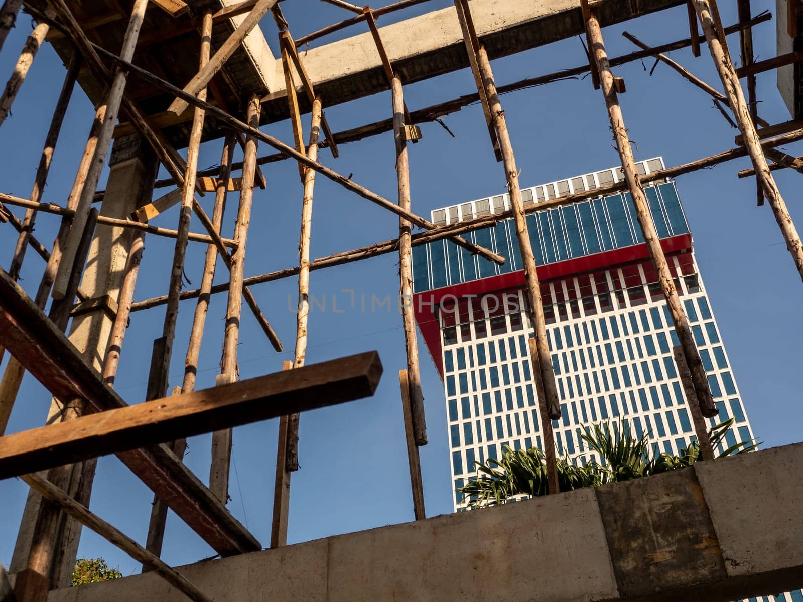 Temporary wooden pole for supports the concrete structure a building under construction