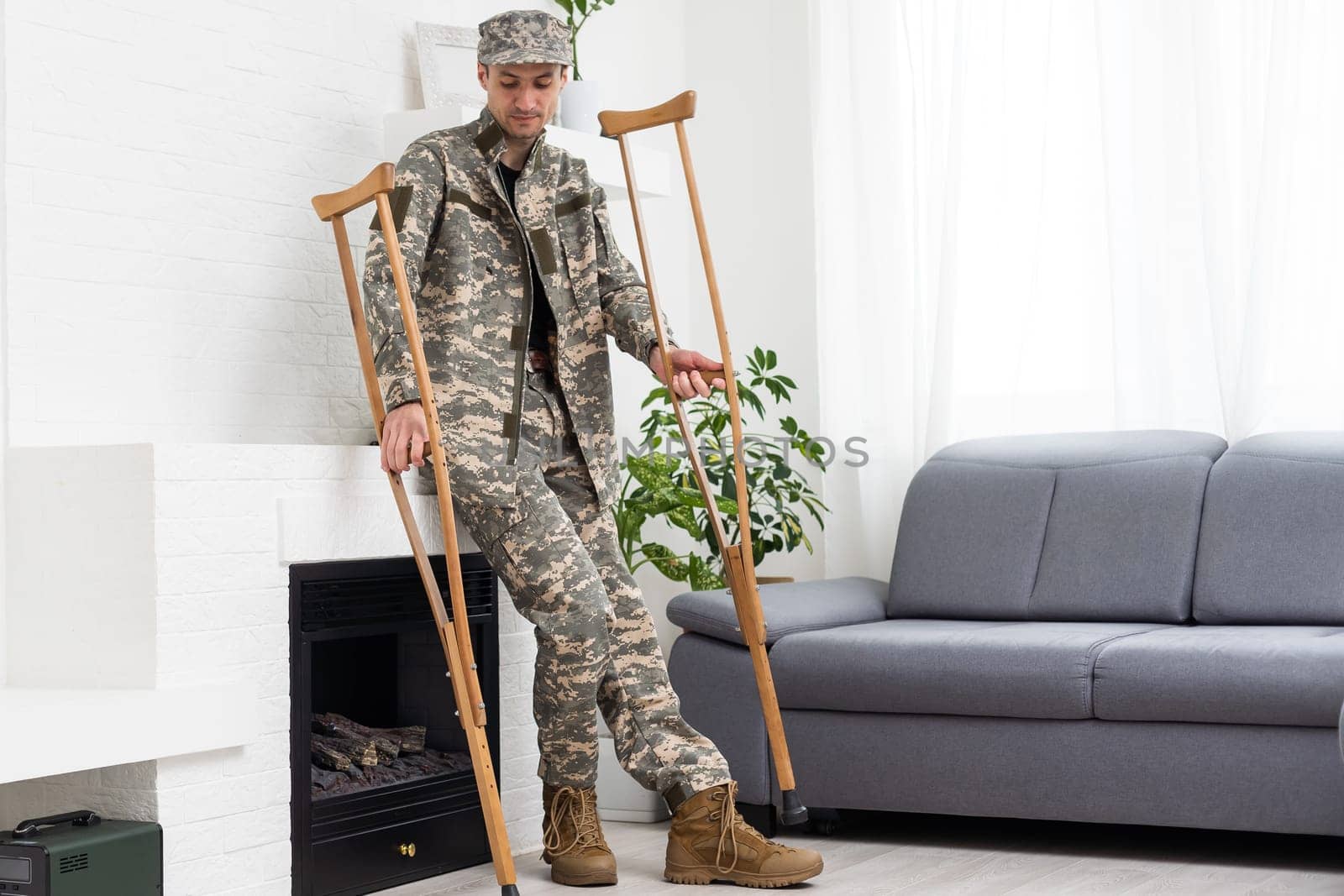 soldier in khaki military uniform on crutches by Andelov13
