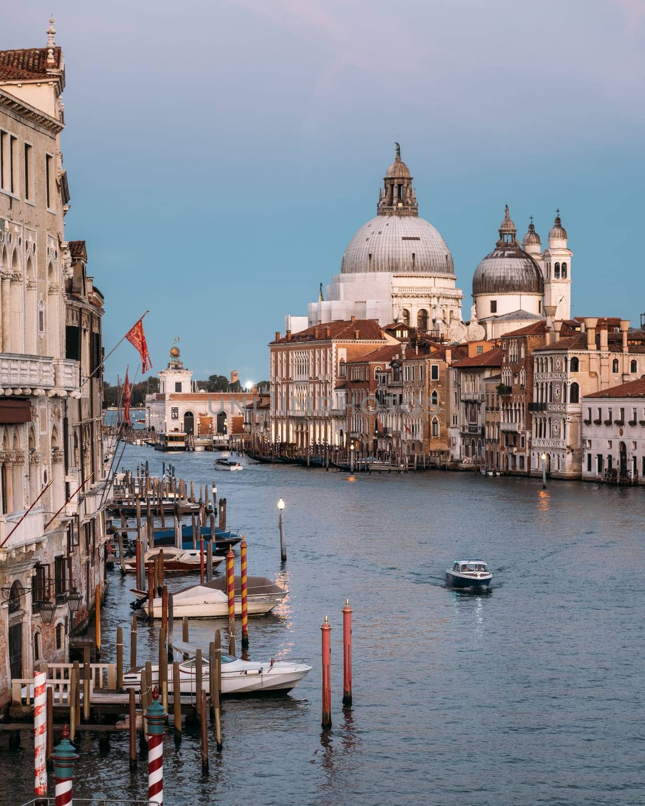 Scenic view of the Salute Roman Catholic church and minor basilica located in Punta della Dogana in the Dorsoduro sestiere of the city of Venice Italy on a cloudless summer evening. Copyspace.