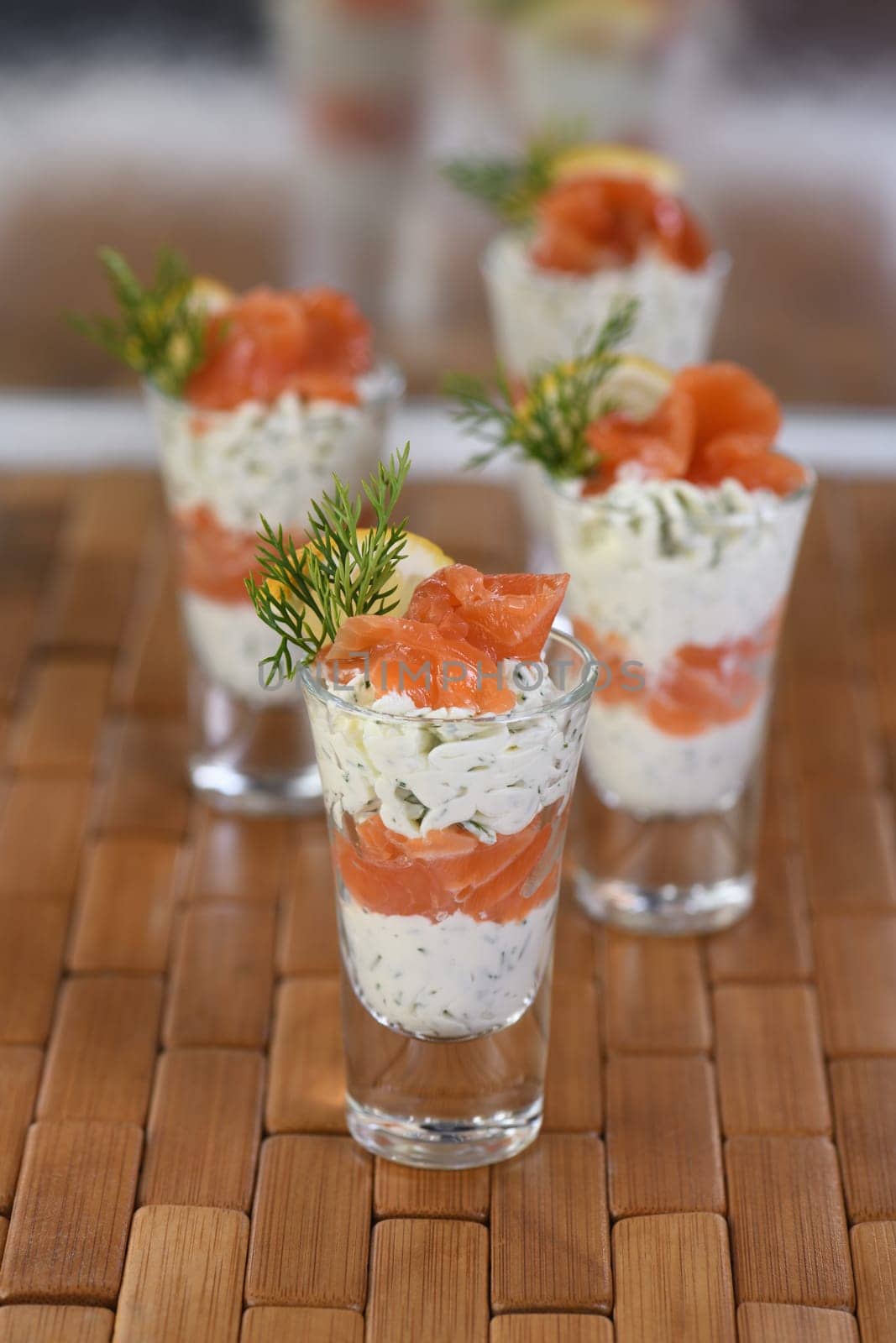 Verrine  from soft cheese cream and salmon, dill sprig and lemon slice. Aperitif appetizer.