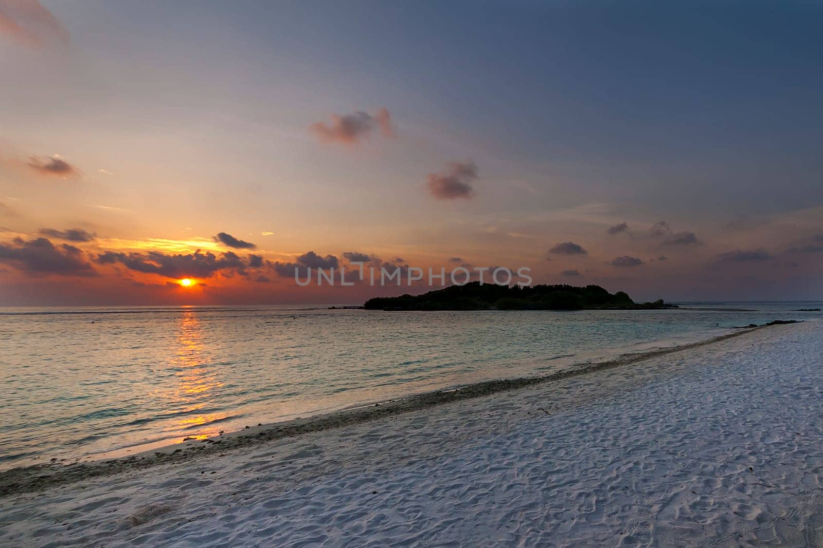 Colorful sunset on an island in the Maldives in the Indian Ocean