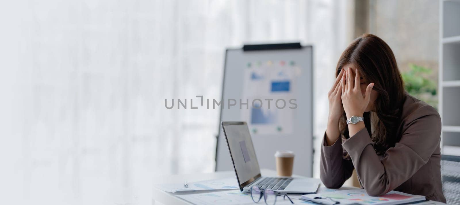 Portrait of sme business owner, woman using computer and financial statements Anxious expression on expanding the market to increase the ability to invest in business.