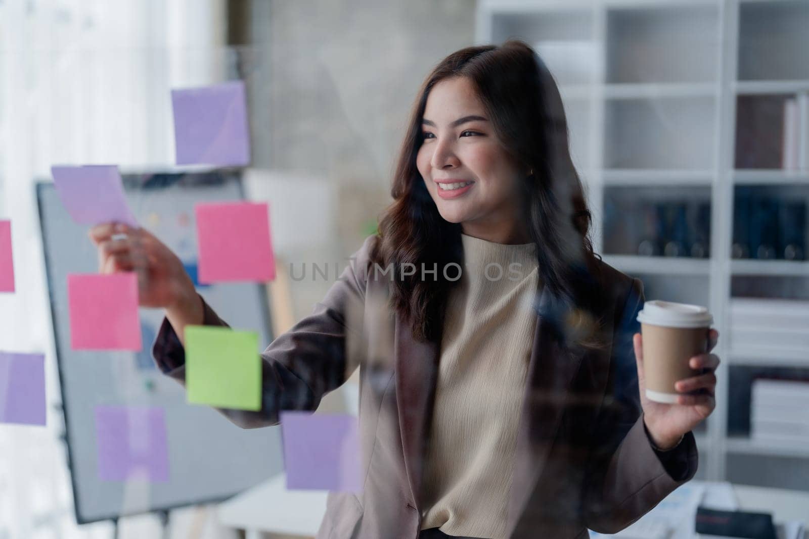 Beautiful young teen asian businesswoman using note pad thinking with planning working on financial document, tax, exchange, accounting and Financial advisor.