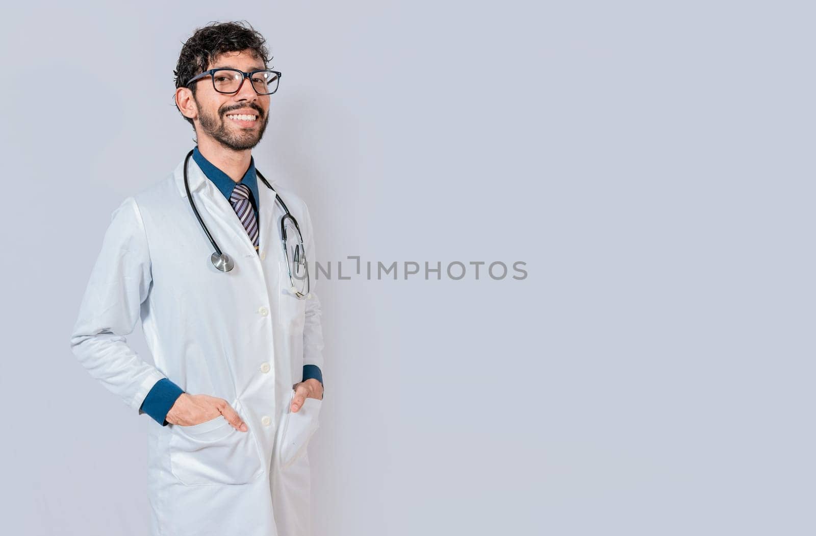 Portrait of happy doctor with hands in pockets  isolated. Happy latin doctor with copy space isolated