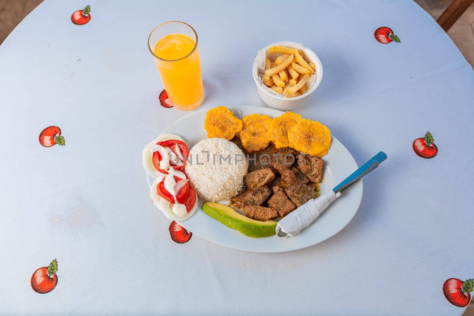 Tradicional lunch served at the table. Top view of traditional lunch with orange juice on the table. by isaiphoto