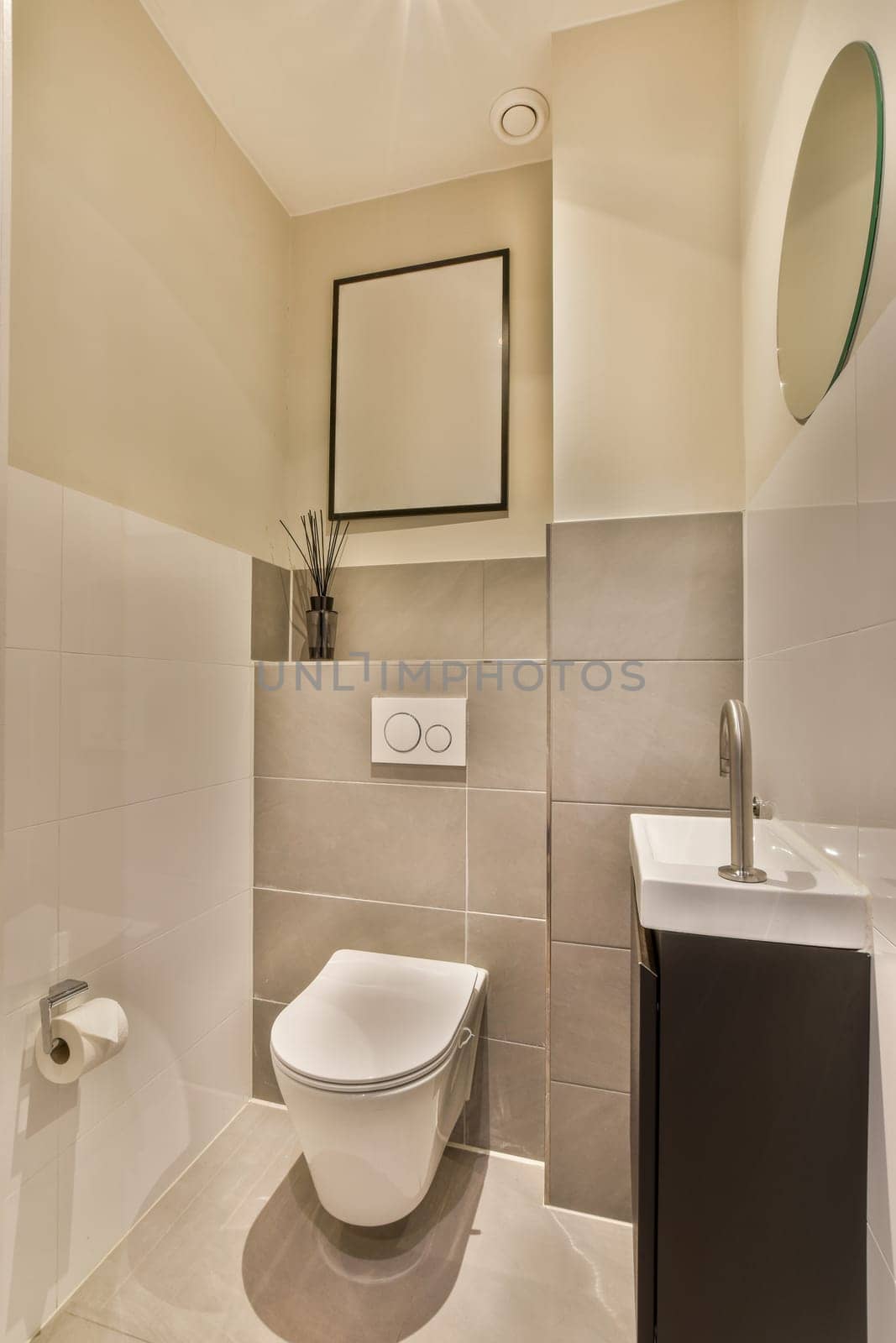 a bathroom with a toilet, sink and mirror on the wall in front of the shower stall is not visible