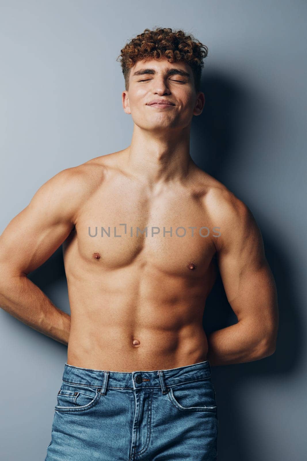 man person shirtless beauty gray background athlete lifestyle fitness bodybuilder muscular chest adult sexy athletic curly studio guy smile