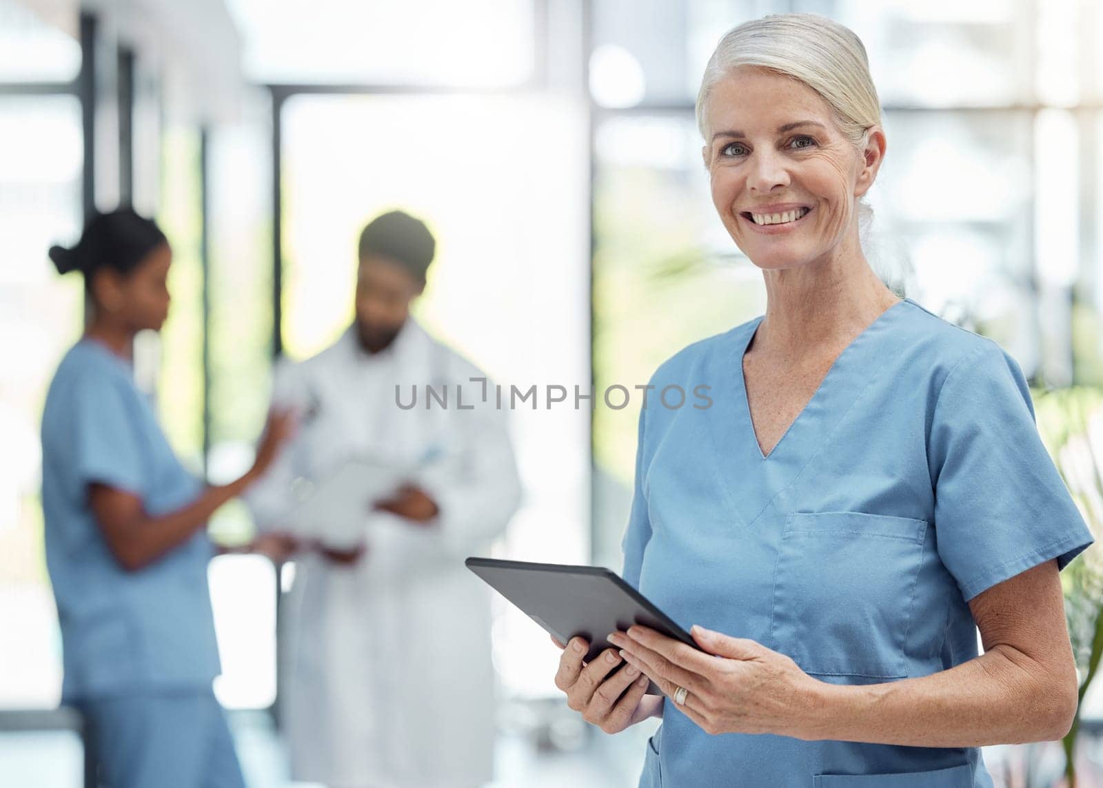 Nurse, health and hospital, woman with tablet and check patient information or digital medical data. Mature, healthcare professional and technology, nursing and clinic with smile in portrait