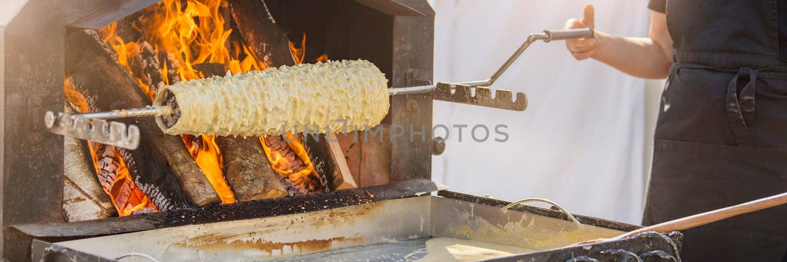 Baumkuchen baking. Making a puff traditional Lithuanian pie in the oven - Shakotis or Spruce pie. High quality photo