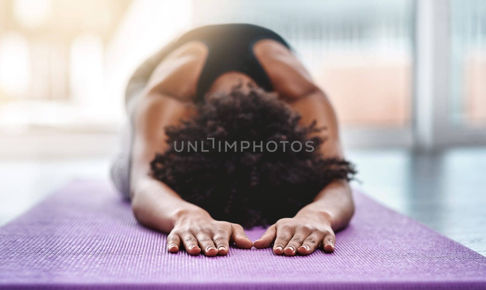 Yoga, fitness and wellness with a woman in studio on an exercise mat for inner peace or to relax. Health, exercise and zen with a female athlete or yogi in the childs pose for balance or awareness by YuriArcurs