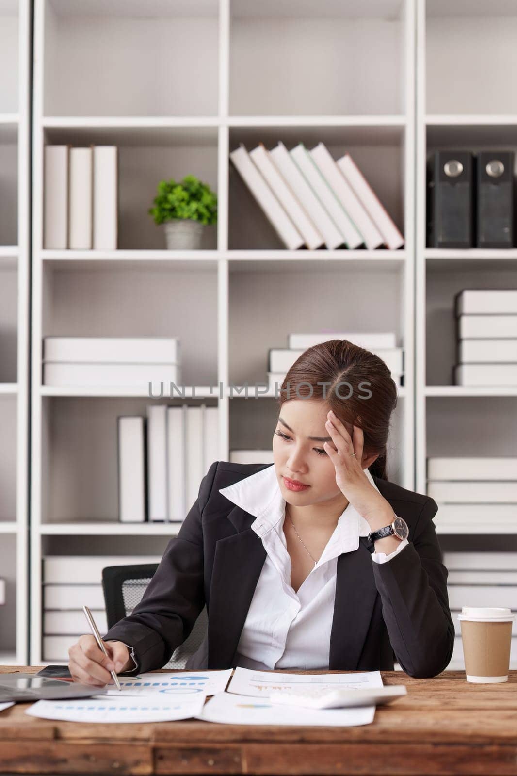 Employee feeling tired stressed with her work in the office, sad working woman overworked overtime, business woman upset with financial document by itchaznong