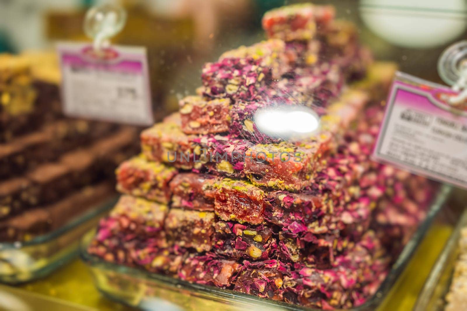 Traditional oriental sweet pastry cookies, nuts, dried fruits, pastilles, marmalade, Turkish desert with sugar, honey and pistachio, in display at a street food market.