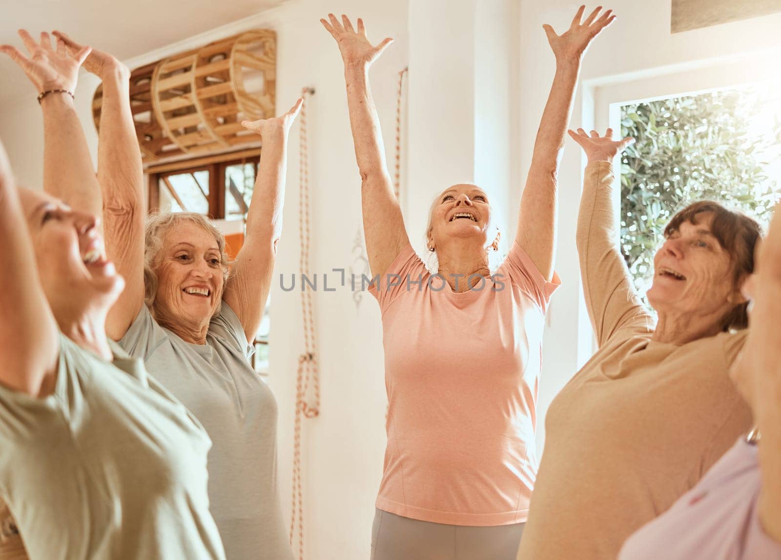 Fitness, success and senior women with their hands up in celebration after yoga or pilates training class. Smile, teamwork and happy elderly friends celebrate wellness goals or target in retirement.