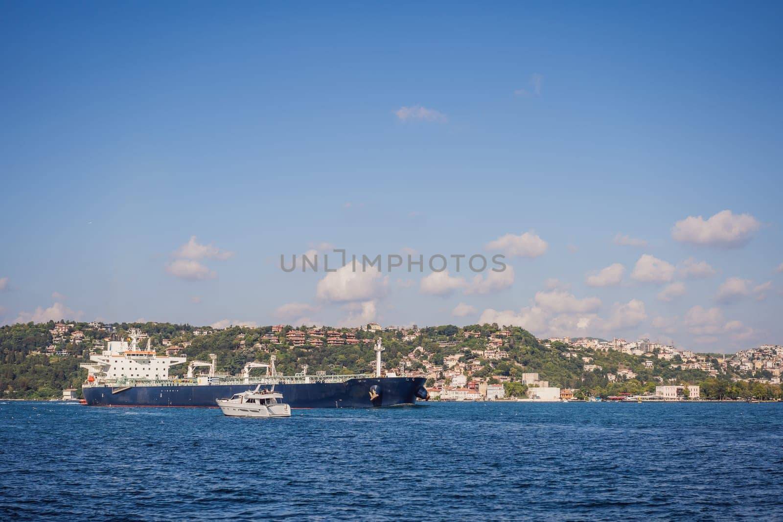 Fatih Sultan Mehmet Bridge Second bridge in Istanbul, Bosphorus with a magnificent looking cargo ship by galitskaya