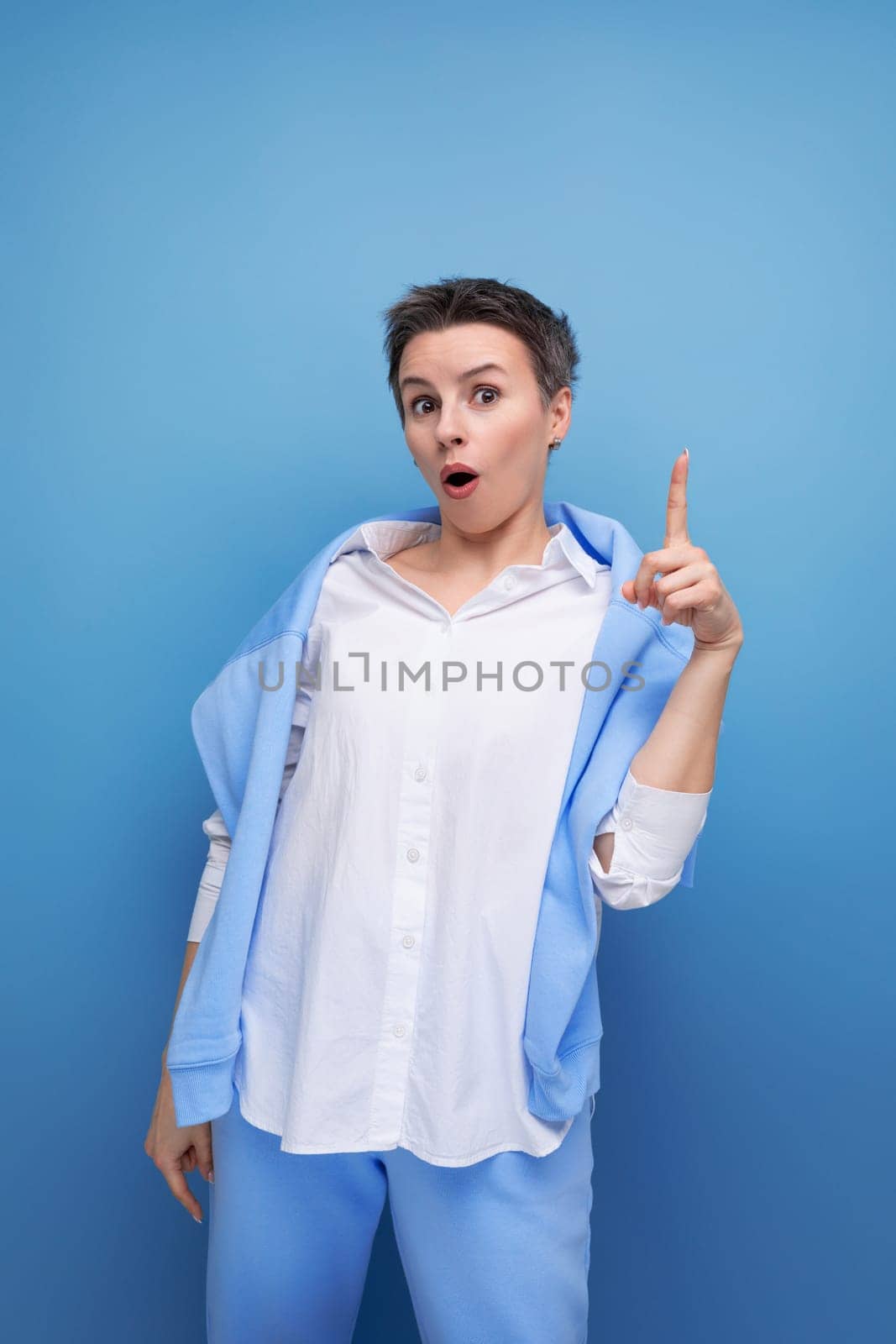 close-up portrait of a charismatic short-haired lady in a casual shirt.