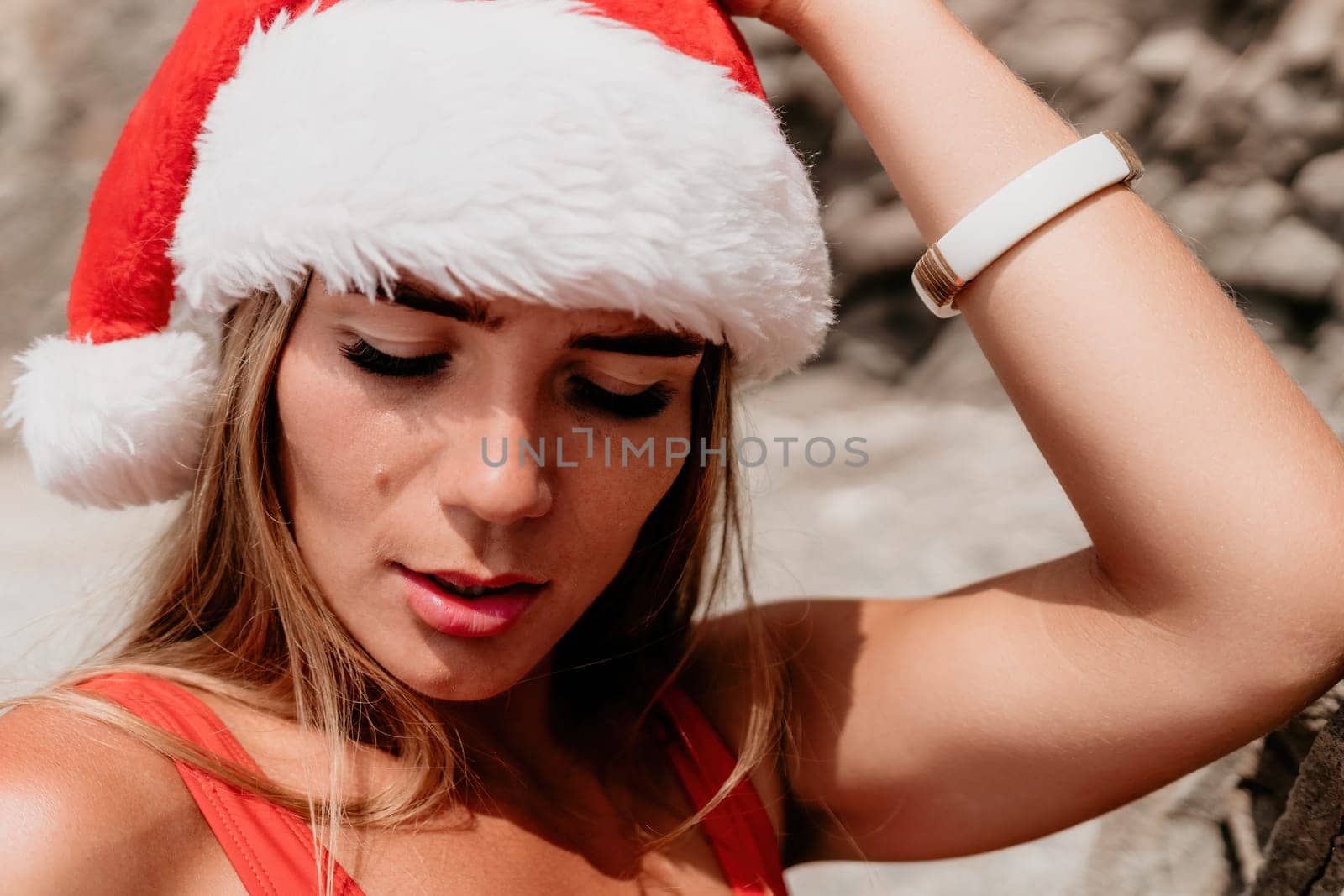 Woman travel sea. Young Happy woman in a long red dress posing on a beach near the sea on background of volcanic rocks, like in Iceland, sharing travel adventure journey